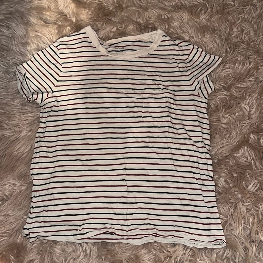 A cream color and burgundy and black colored shirt with a little pocket